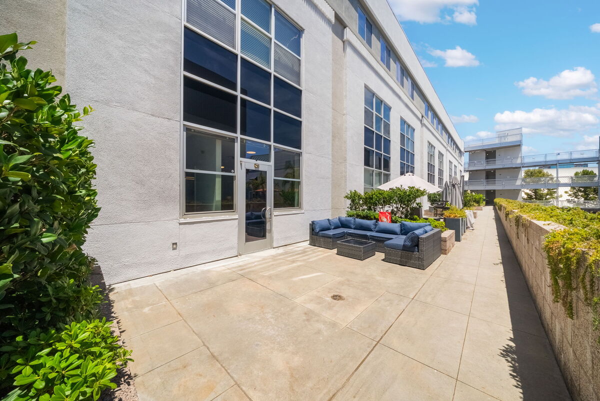 Soaring loft windows and patio